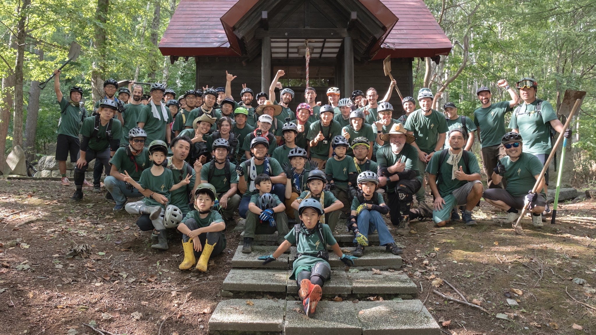 Multi-generational NAMBA volunteers gathered after a dig day at the forest shrine
