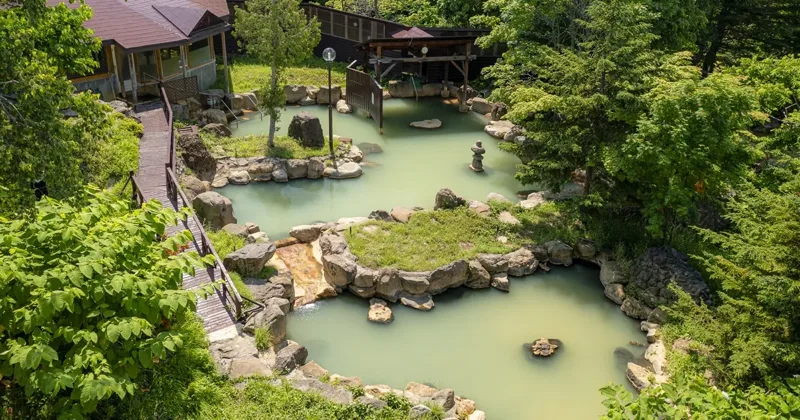 Outdoor onsen with mountain views, where a Niseko ride ends