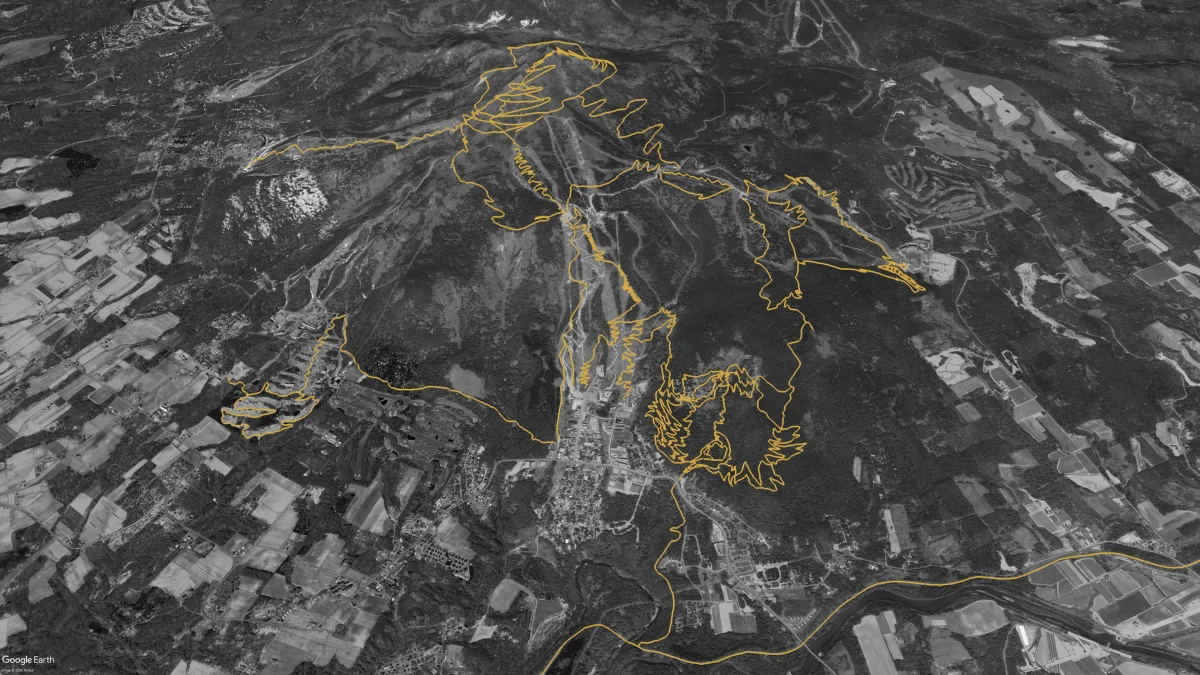 Aerial view of the Niseko region with the planned NAMBA trail network traced in gold across Mount Annupuri, Grand Hirafu, Hanazono, and Twin Peaks